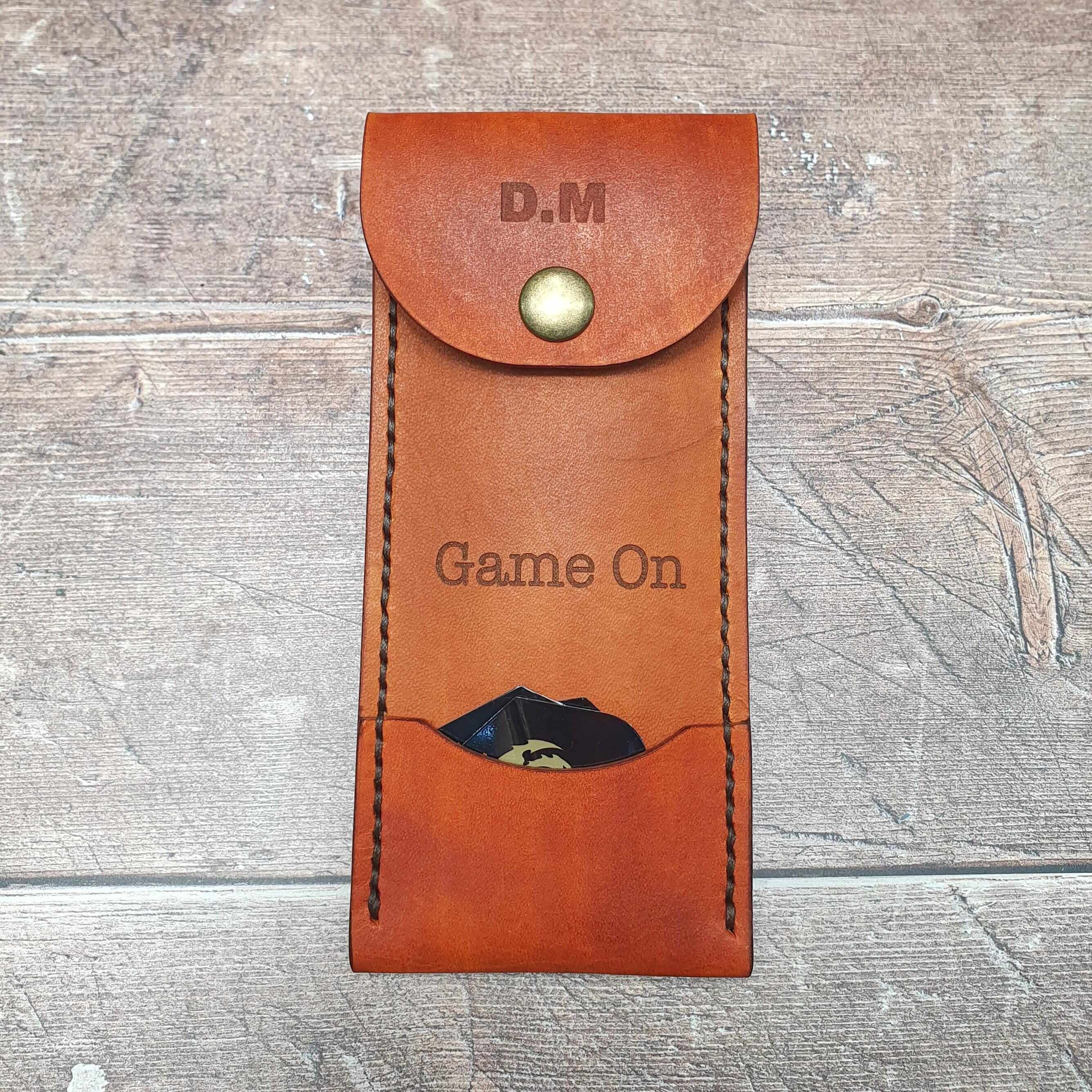 Personalized leather darts case featuring a snap closure, custom engraving, and pocket for darts and flights.