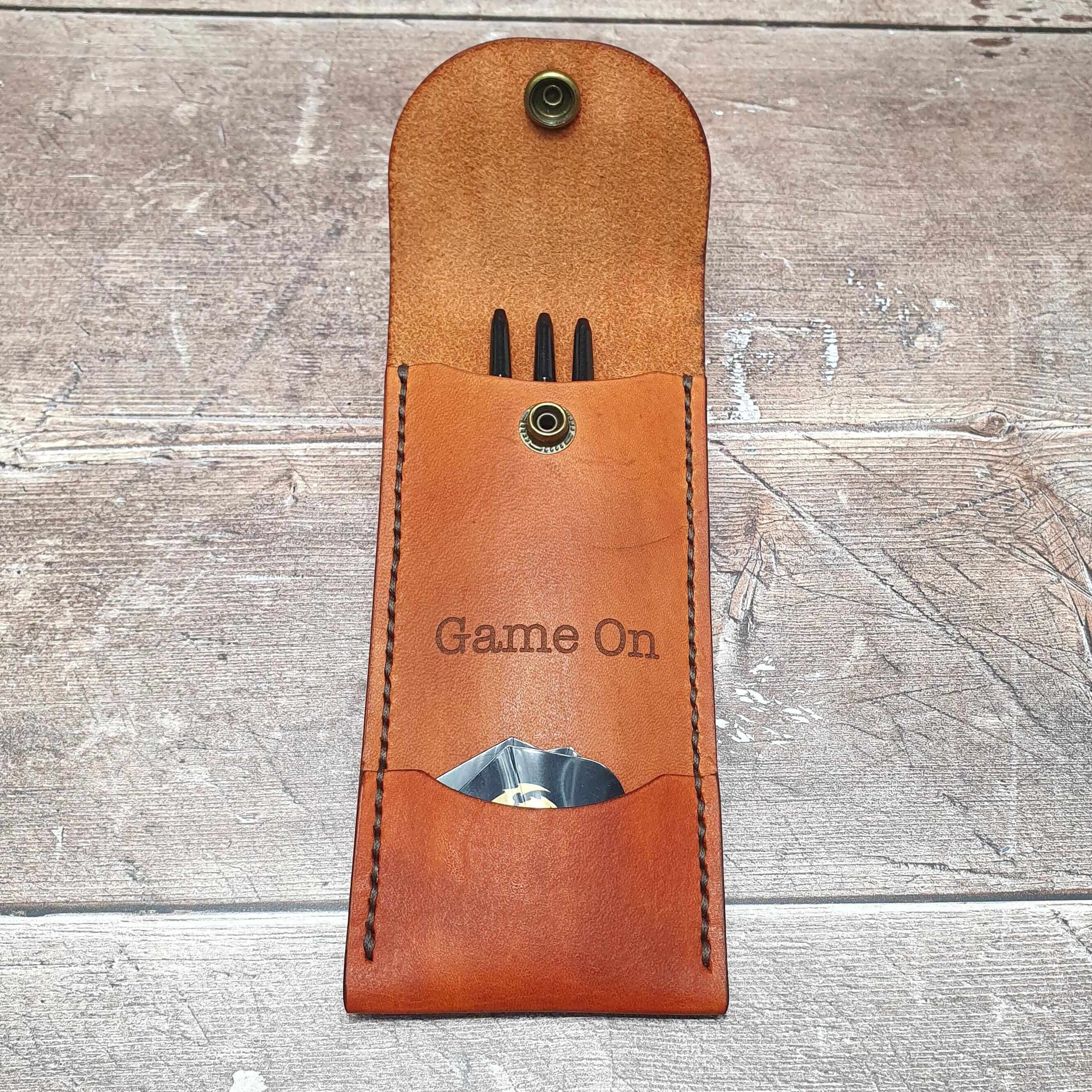 Personalized leather darts case with darts and 'Game On' engraving for dart players.