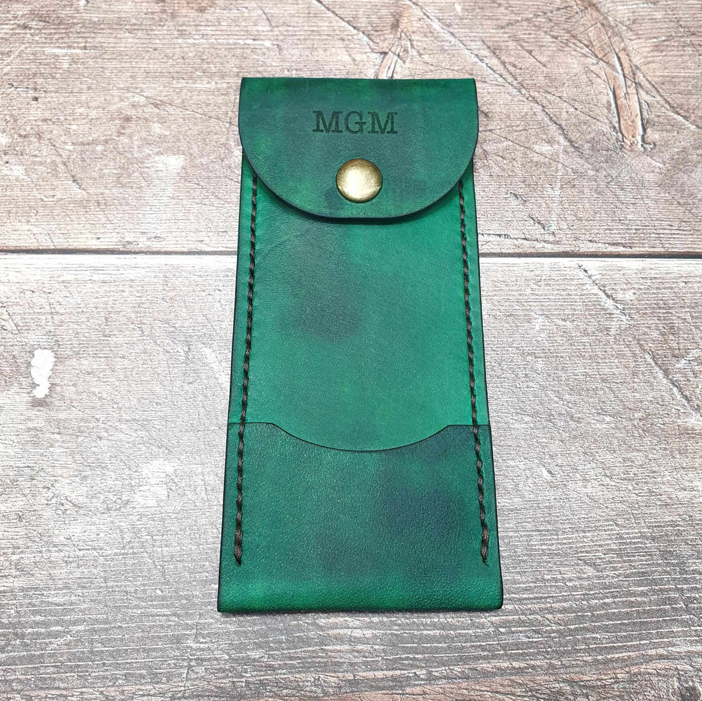 Personalized leather darts case in green with snap popper fastening and custom initials on top.